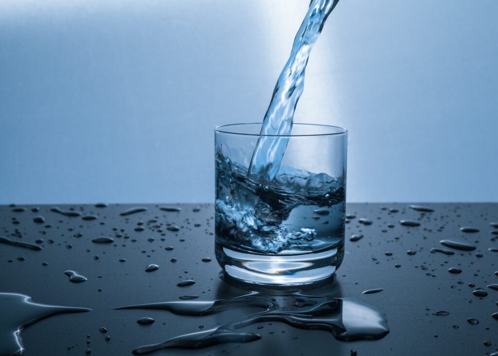 A glass of water being fillde